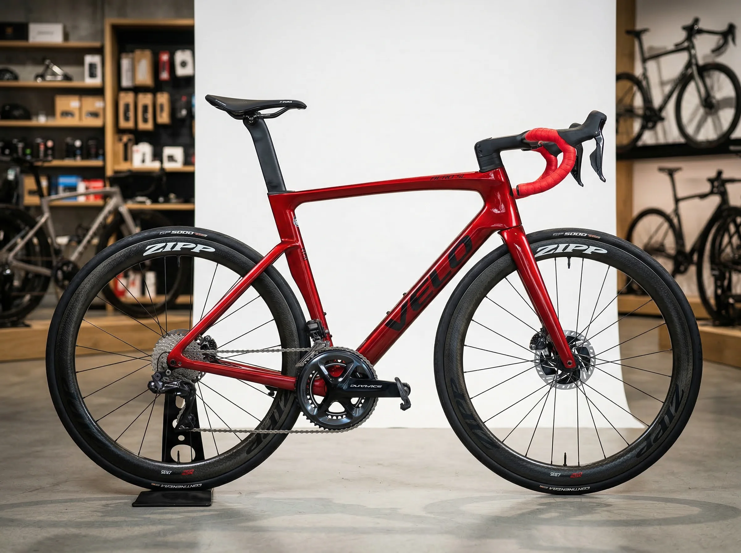 Racing red carbon fiber road bike with disc brakes displayed in shop